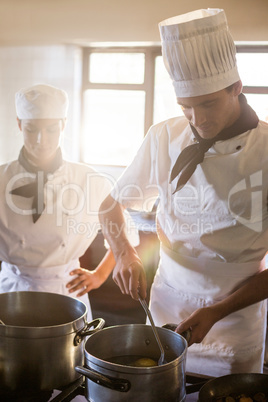 Chefs preparing food at stove