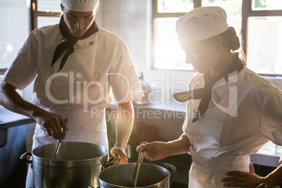 Chefs preparing food at stove