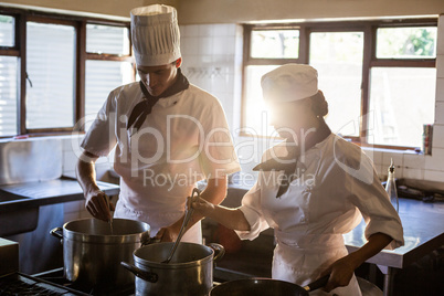 Chefs preparing food at stove