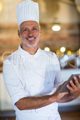Portrait of chef using digital tablet