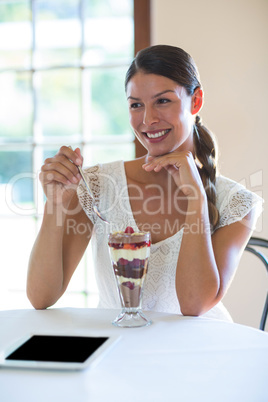 Smiling, woman eating dessert