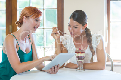 Women discussing with a digital tablet