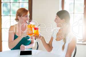 Two women drinking cocktail