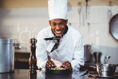 Portrait of smiling chef preparing a salad