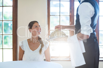 Waiter serving food to women in restaurant