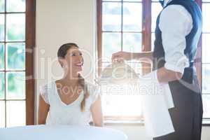 Waiter serving food to women in restaurant