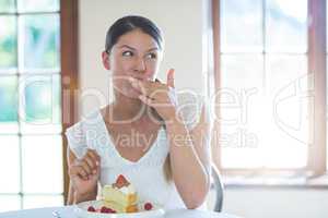 Woman having a pastry in restaurant