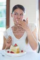 Woman having a pastry in restaurant