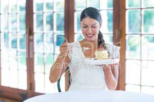 Woman having a pastry in restaurant