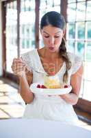 Woman having a pastry in restaurant