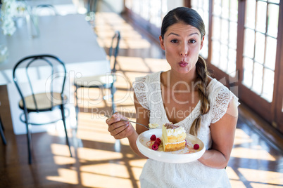 Portrait of woman having a pastry in restaurant