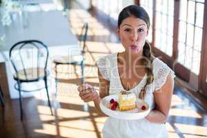 Portrait of woman having a pastry in restaurant