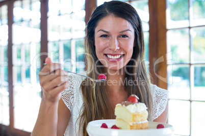 Portrait of woman having a pastry in restaurant