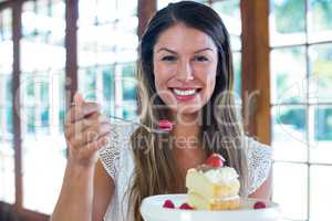 Portrait of woman having a pastry in restaurant