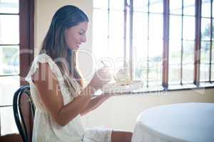 Woman having a pastry in restaurant