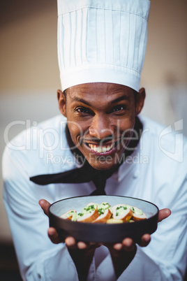 Portrait of head chef presenting salad