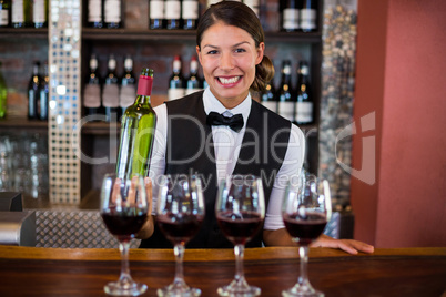 Four glasses of red wine ready to serve on bar counter