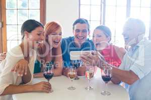 Group of friends looking at the mobile phone