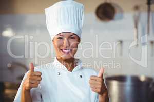 Portrait of smiling chef showing thumbs up