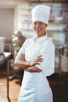 Portrait of happy chef standing with arms crossed