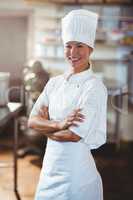 Portrait of happy chef standing with arms crossed