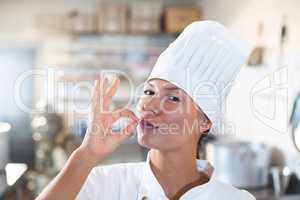 Portrait of female chef making ok sign
