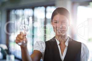 Waitress holding up a empty wine glass
