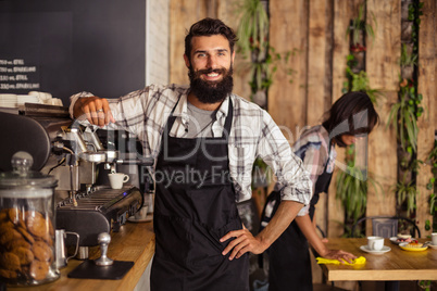 Waiter using a coffee machine