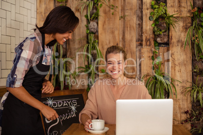 Waitress serving a coffee to a customer