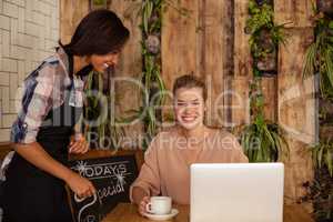 Waitress serving a coffee to a customer