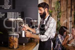 Waiter using a coffee machine