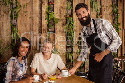 Waiter serving coffees