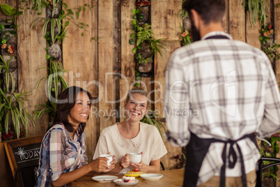 Waiter interacting with customers