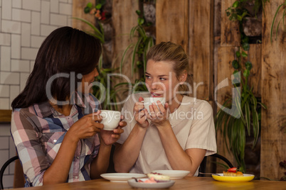 Two customers drinking coffee