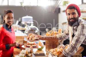 Seller serving a cake to the customer