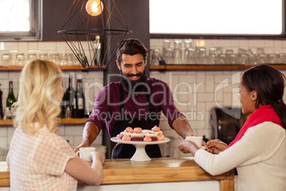 Bartender serving coffee to customers