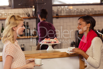 Customers drinking a coffee with the bartender