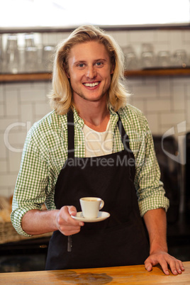 Portrait of a bartender holding a cup of coffee Portrait of a bartender holding a cup of coffee