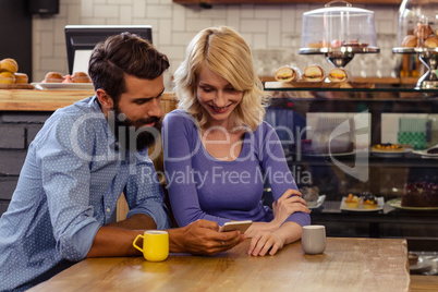 Lovely couple using a smartphone