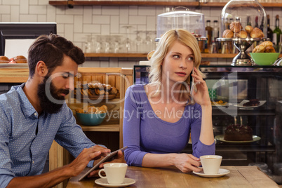 Couple using smartphones with a phonecall
