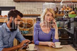 Couple using smartphones with a phonecall