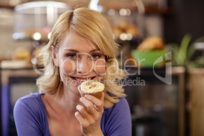 Customer holding a muffin