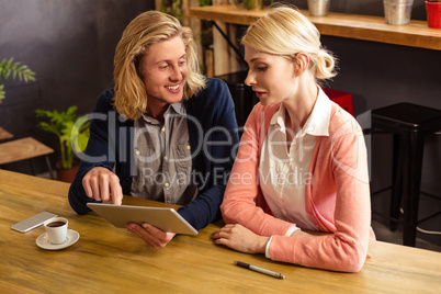 Workmates using a tablet computer