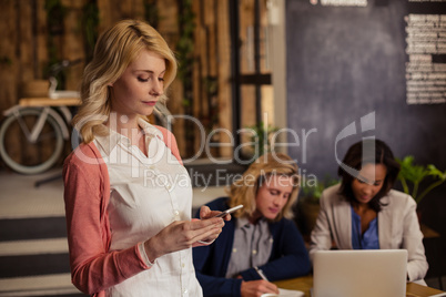 Casual businesswoman using a smartphone