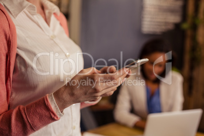 Casual businesswoman using a smartphone