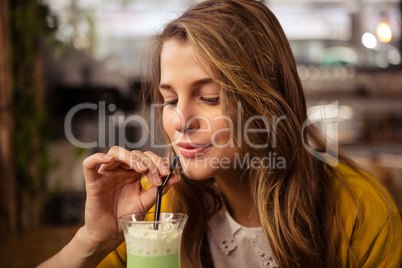 Casual woman drinking a cocktail