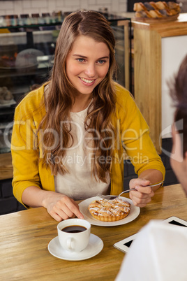 Casual woman eating a cake with a man