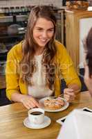 Casual woman eating a cake with a man
