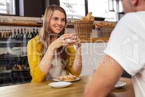 Casual woman drinking a coffee with a man
