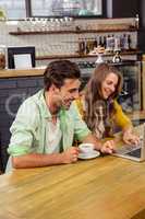 Smiling couple using a laptop